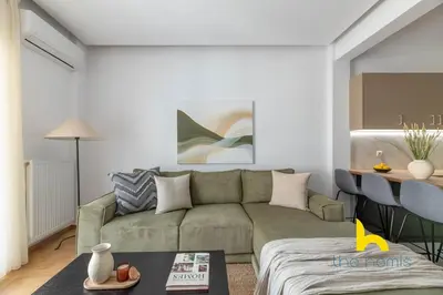a living room with a couch and a table at Chic Koukaki Haven Steps to Metro & Acropolis! in Athens