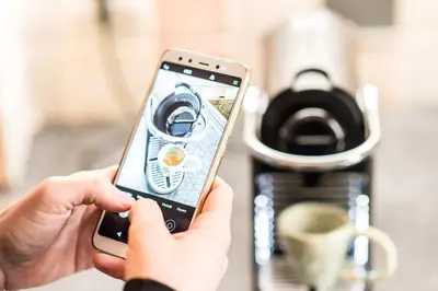 a person holding a cell phone in front of a coffee maker at Urban Piraeus, Apartment No 2 in Piraeus