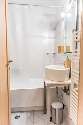 a white bathroom with a sink and a tub at Urban Piraeus, Apartment No 2 in Piraeus