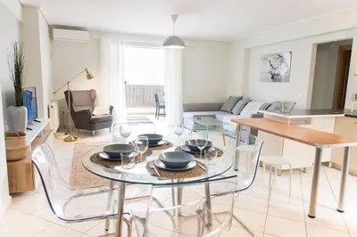 a living room with a table and chairs at Urban Piraeus, Apartment No 2 in Piraeus