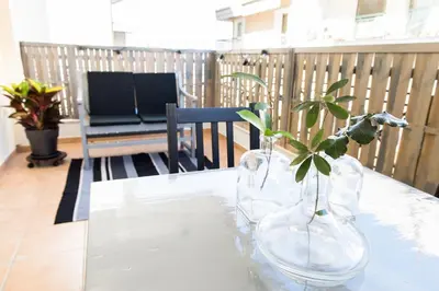a table with two glass vases with a plant in it at Urban Piraeus, Apartment No 2 in Piraeus