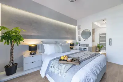 a bedroom with a large bed with a tray of fruit on it at 50 Shades of Athens, Kingsize Suite with Jacuzzi! in Athens
