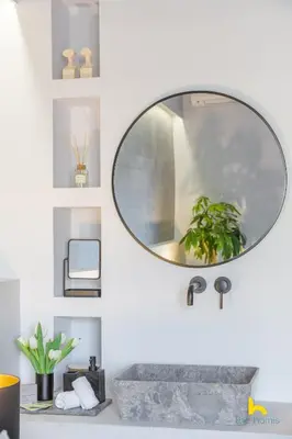 a bathroom with a round mirror on the wall at 50 Shades of Athens, Kingsize Suite with Jacuzzi! in Athens