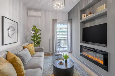 a living room with a couch and a fireplace at 50 Shades of Athens, Kingsize Suite with Jacuzzi! in Athens
