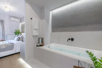 a white bathroom with a tub in a bedroom at 50 Shades of Athens, Kingsize Suite with Jacuzzi! in Athens