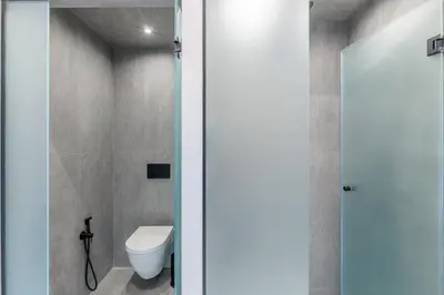 a bathroom with a white toilet in a room at 50 Shades of Athens, Kingsize Suite with Jacuzzi! in Athens