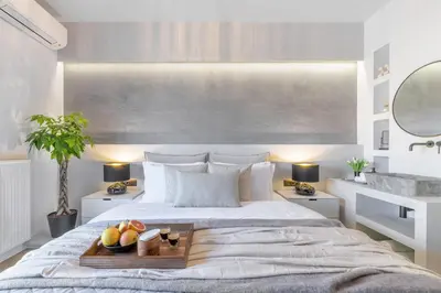 a bedroom with a bed with a tray of fruit on it at 50 Shades of Athens, Kingsize Suite with Jacuzzi! in Athens