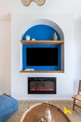 a living room with a fireplace and a tv at Aegean Blue Hideaway w Fireplace, near Acropolis in Athens