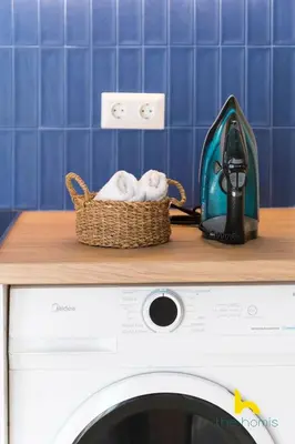 a basket of towels sitting on top of a washing machine at Aegean Blue Hideaway w Fireplace, near Acropolis in Athens
