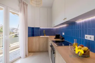 a kitchen with blue tiled walls and a counter at Aegean Blue Hideaway w Fireplace, near Acropolis in Athens