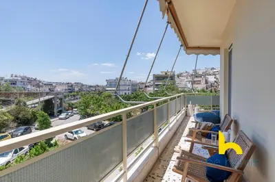 a balcony with chairs and a view of a city at Aegean Blue Hideaway w Fireplace, near Acropolis in Athens