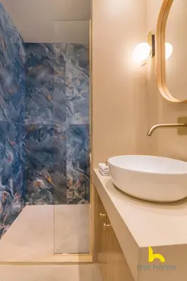 a bathroom with a white sink and a mirror at Aegean Blue Hideaway w Fireplace, near Acropolis in Athens