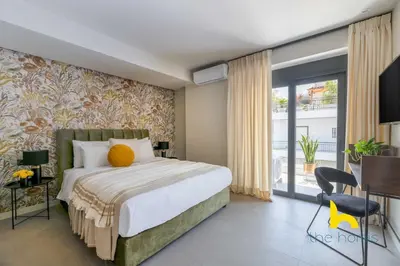 a bedroom with a large bed and a sliding glass door at Majestic Acropolis View w Large Patio & Parking in Athens