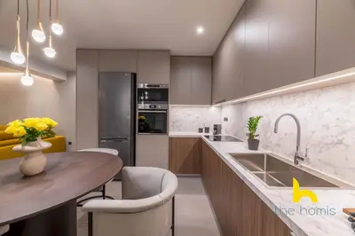 a kitchen with a sink and a table with chairs at Majestic Acropolis View w Large Patio & Parking in Athens
