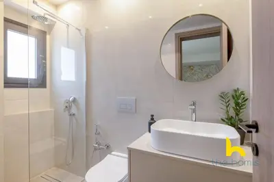 a bathroom with a sink and a toilet and a mirror at Majestic Acropolis View w Large Patio & Parking in Athens
