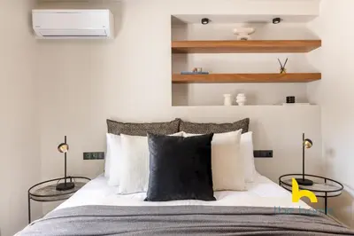 a bedroom with a large bed with two lamps at Majestic Acropolis View w Large Patio & Parking in Athens