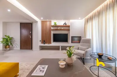 a living room with a couch and a television at Majestic Acropolis View w Large Patio & Parking in Athens