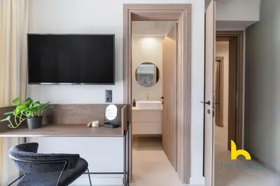 a room with a television and a desk with a chair at Majestic Acropolis View w Large Patio & Parking in Athens