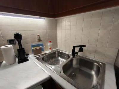 a kitchen sink with a faucet on a counter at Boutique Studio 100m from the Sea in Piraeus in Piraeus