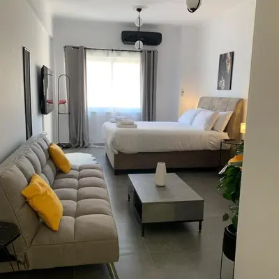a living room with a bed and a couch at Urban Hermes Apartment in Athens