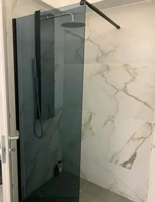 a shower with a glass door in a bathroom at Urban Hermes Apartment in Athens