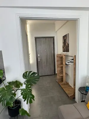 a living room with a door and a plant at Urban Hermes Apartment in Athens