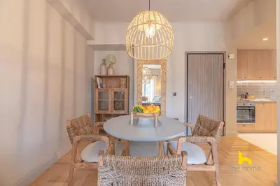 a dining room with a table with chairs and a chandelier at Sun-Kissed Boho Haven with Whirlpool Bliss & Patio in Athens