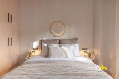 a white bedroom with a large bed with white pillows at Sun-Kissed Boho Haven with Whirlpool Bliss & Patio in Athens