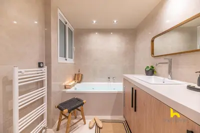 a bathroom with a tub and a sink at Sun-Kissed Boho Haven with Whirlpool Bliss & Patio in Athens