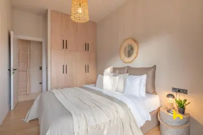a bedroom with a large bed with white sheets at Sun-Kissed Boho Haven with Whirlpool Bliss & Patio in Athens