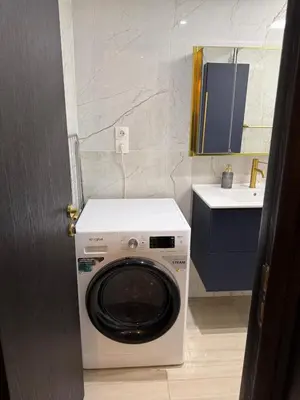a washing machine in a bathroom with a sink at Zeas Meridian Suite Piraeus Athens in Piraeus