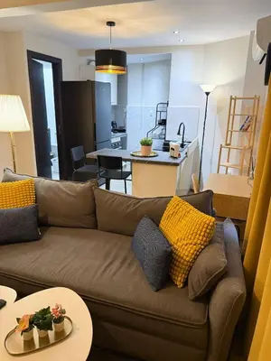 a living room with a couch and a kitchen at Zeas Meridian Suite Piraeus Athens in Piraeus
