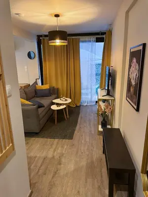 a living room with a couch and a table at Zeas Meridian Suite Piraeus Athens in Piraeus