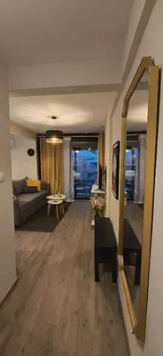 a living room with a couch and a mirror at Zeas Meridian Suite Piraeus Athens in Piraeus