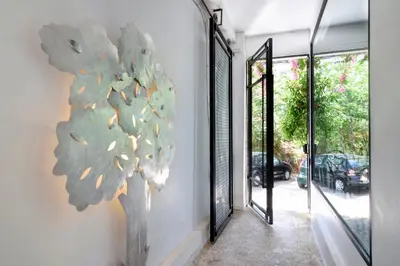 a painting of a tree on the side of a wall at Athens Green Apartments in Athens