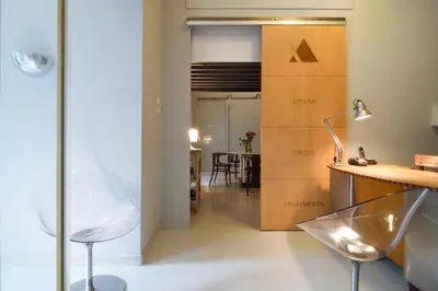 a room with a chair and a table and a box at Athens Green Apartments in Athens