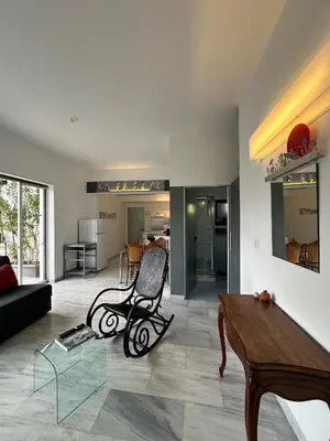 a living room with a chair and a table at Athens Green Apartments in Athens