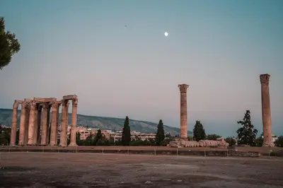 a group of columns with a city in the background at Athens Green Apartments in Athens