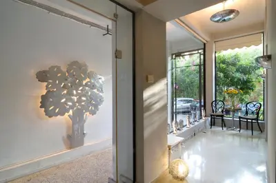 a hallway with a tree mural on the wall at Athens Green Apartments in Athens