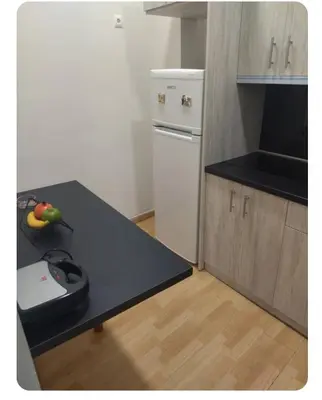 a kitchen with a black counter top and a refrigerator at Neoclassic Rooms in Athens