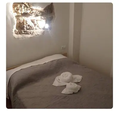 a room with a bed with two towels on it at Neoclassic Rooms in Athens