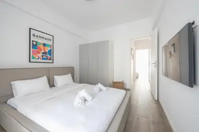 a bedroom with a white bed with towels on it at The Art Boutique Loft in Athens
