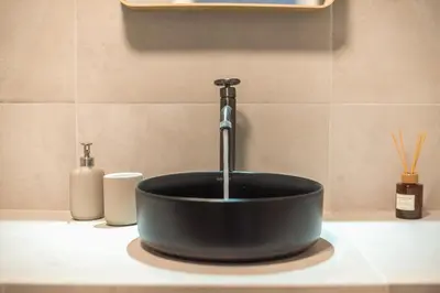 a black sink with a faucet on a counter at The Art Boutique Loft in Athens