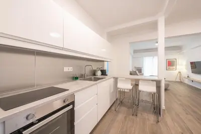 a white kitchen with a sink and a counter at The Art Boutique Loft in Athens