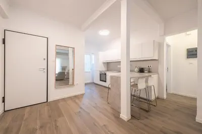 a kitchen with white walls and a wooden floor at The Art Boutique Loft in Athens