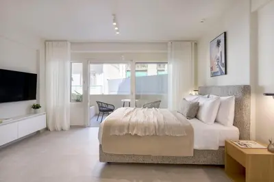 a bedroom with a large bed and a television at Boutique Studio Ι in Central Athens by MPS in Athens