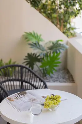 a white table with a plate of grapes on it at Boutique Studio Ι in Central Athens by MPS in Athens