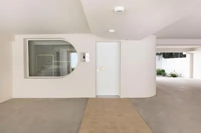 a white room with a door and a mirror at Boutique Studio Ι in Central Athens by MPS in Athens