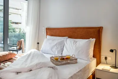 a bed with a basket of fruit on it at Elegant Studio Near Seafront- Palaio Faliro by MPS in Athens