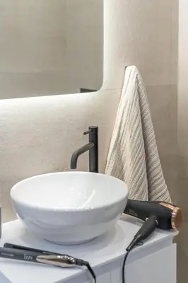 a white sink sitting on top of a bathroom counter at Elegant Studio Near Seafront- Palaio Faliro by MPS in Athens